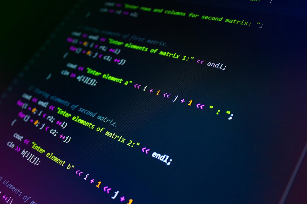 Close-up of colorful programming code displayed on a monitor screen.